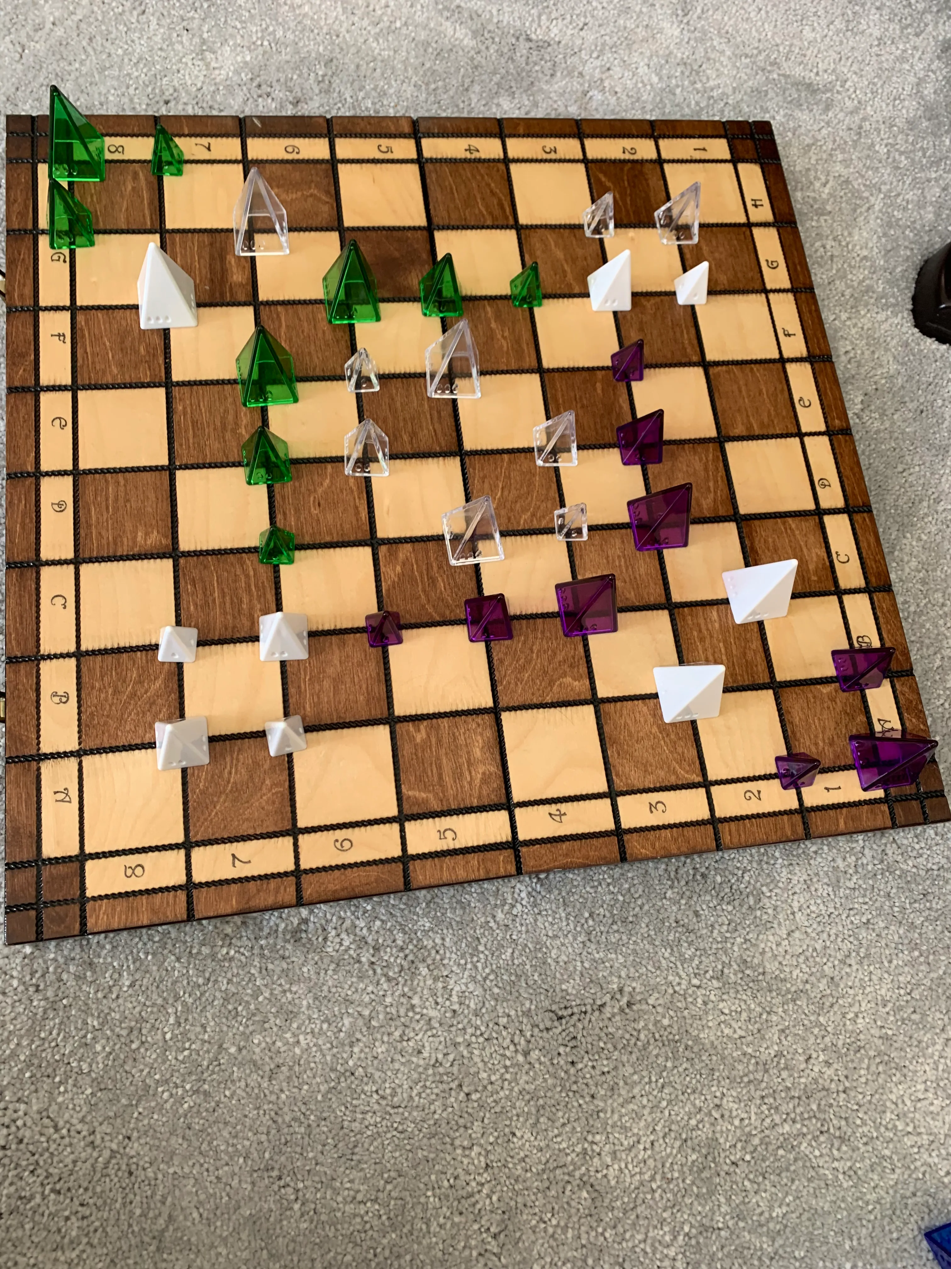 Playing Gate, a game Toby created using pyramid arcade pieces and chess board